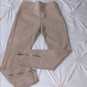Bebe tan pants with gold zippers on the back.
